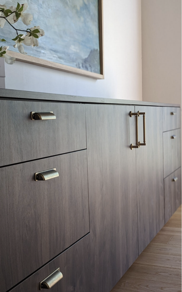 dark frameless cabinets with bronze hardware