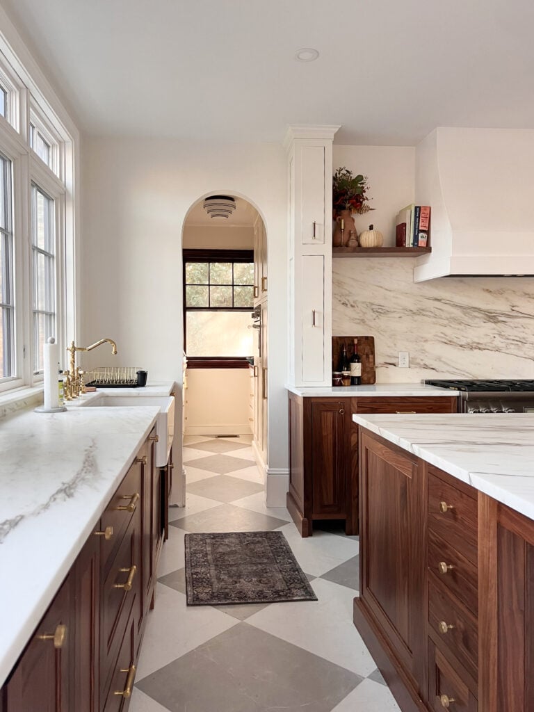 Walnut kitchen with inset cabinets and dark cabinets