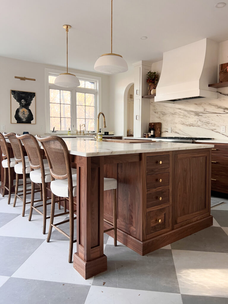 Walnut kitchen island with plaster range hood